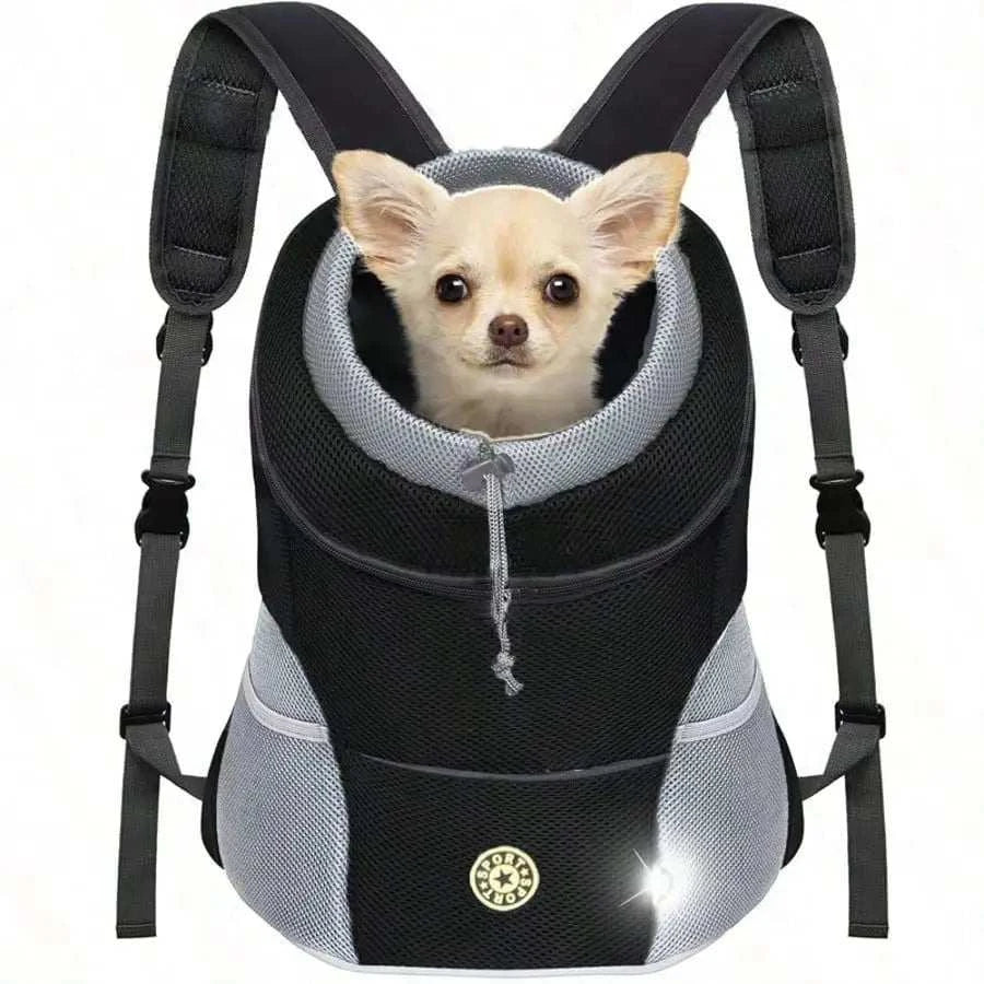 A small dog carrier backpack with a light-colored Chihuahua inside, featuring a black and gray mesh design with padded shoulder straps and a front zipper.